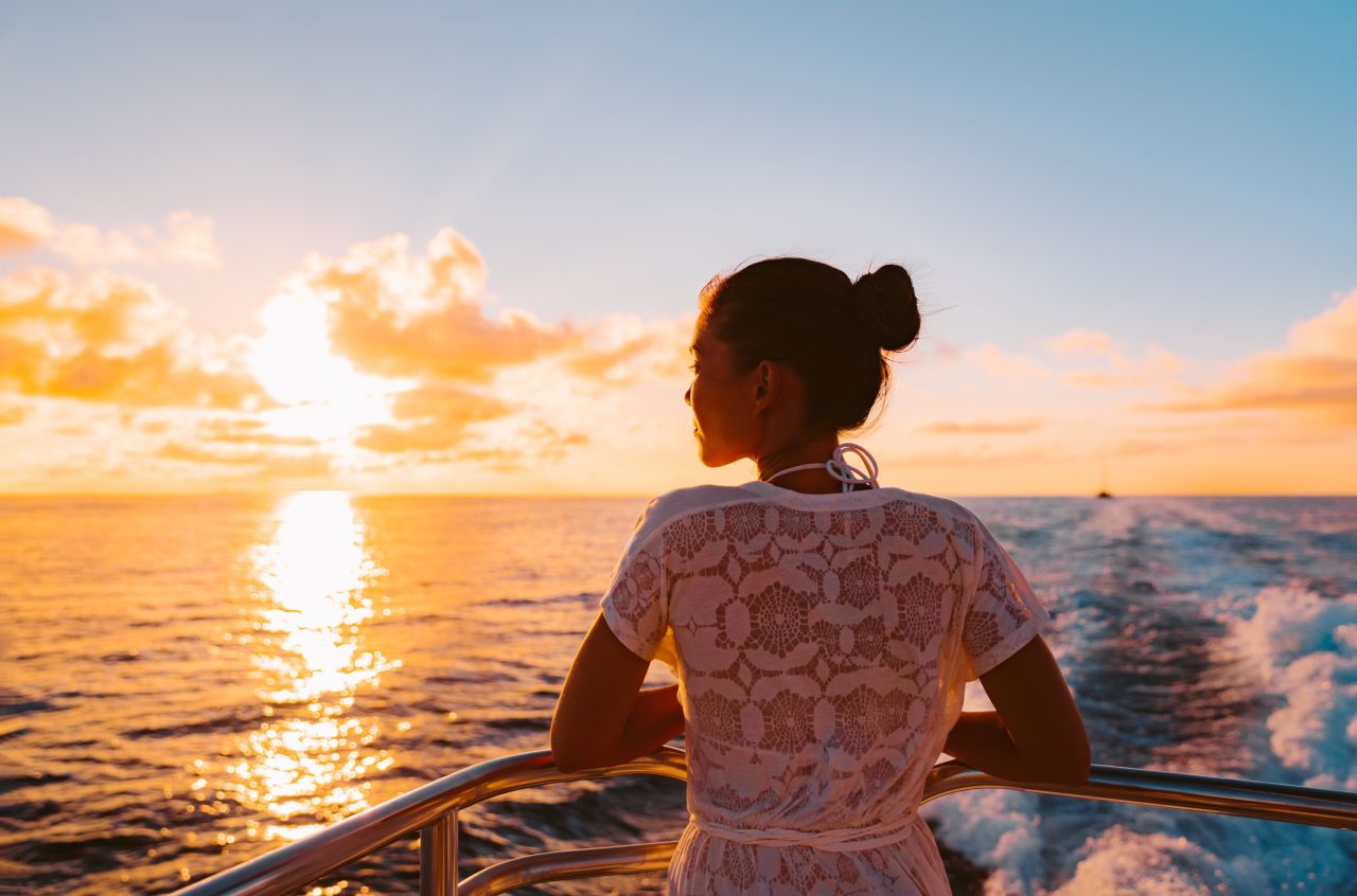 Woman overlooking sea from cruise ship